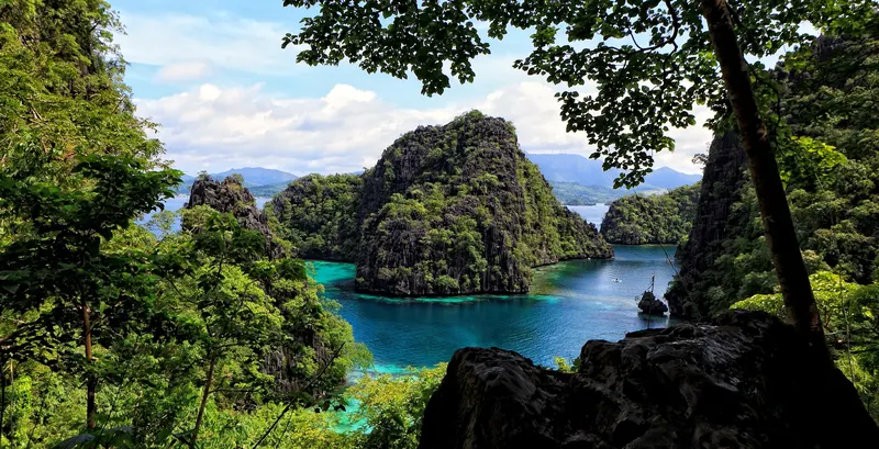 Stunning Coron, Palawan with crystal-clear turquoise waters and lush green surroundings.