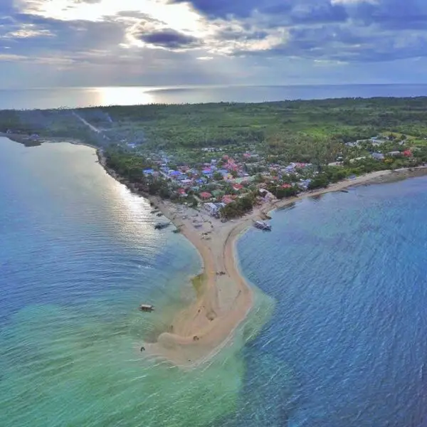 Aerial view of Higatangan Island, featuring white sandy beaches, turquoise waters, and lush greenery.