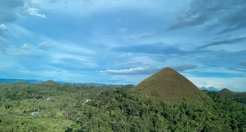 Iconic Chocolate Hills: A stunning landscape dotted with hundreds of unique conical hills, resembling chocolate mounds, set against a backdrop of lush greenery.