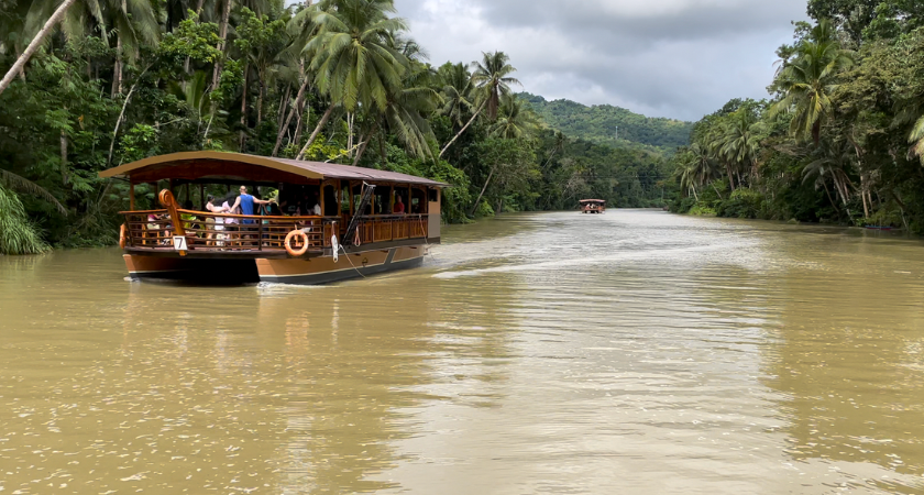 Loboc River Cruise: A scenic riverboat journey along the tranquil Loboc River, surrounded by lush tropical forests and charming riverside communities.