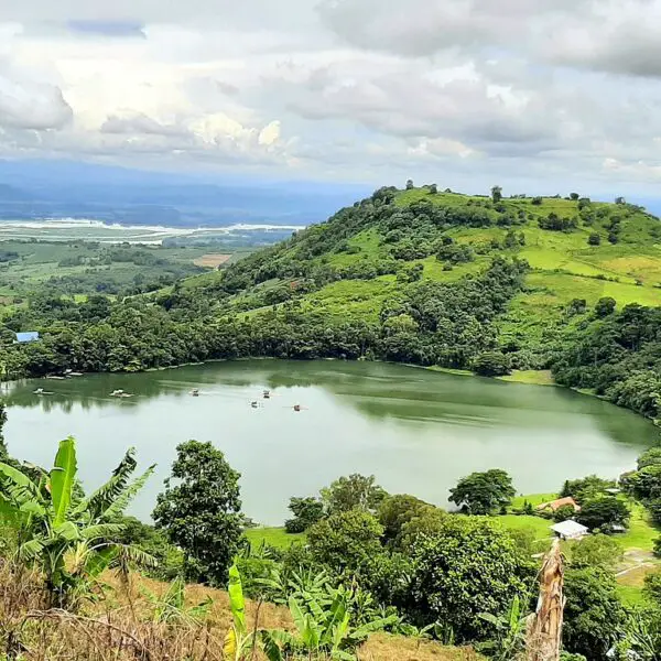 Lake Apo in Bukidnon reflecting the surrounding mountains and lush greenery