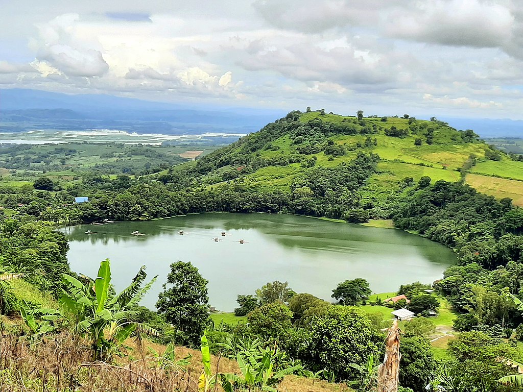 Lake Apo in Bukidnon reflecting the surrounding mountains and lush greenery