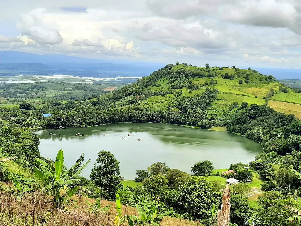 Lake Apo in Bukidnon reflecting the surrounding mountains and lush greenery