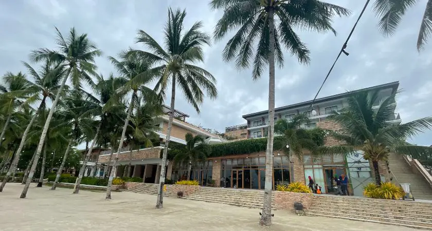 Exquisite facade of Modala Beach Resort, featuring modern architecture and a welcoming entrance adorned with lush tropical greenery.