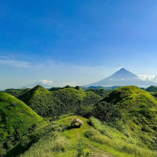 A scenic view of Quitinday Hills and Nature Park in Albay, showcasing lush green hills and a peaceful atmosphere