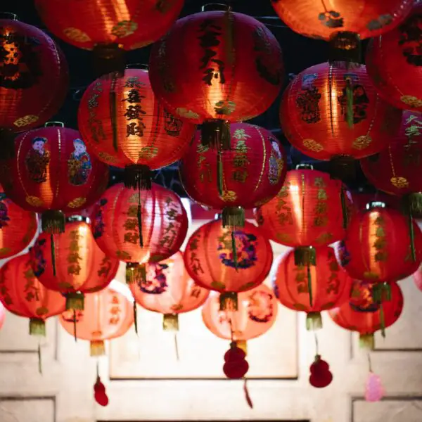 traditional asian paper lanterns hanging on street at night