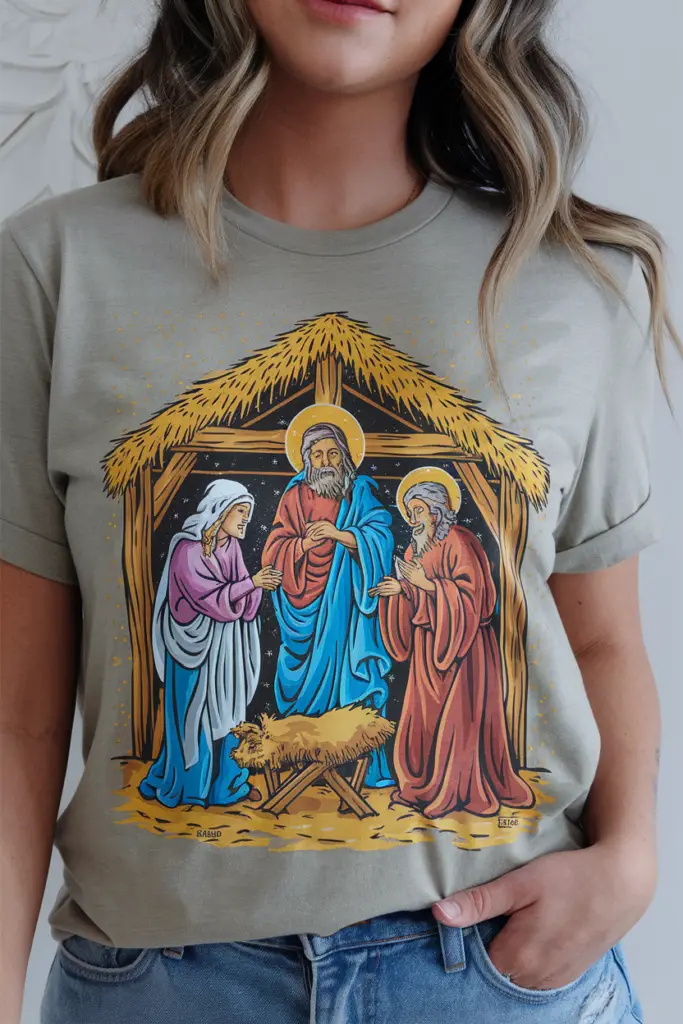 A photo of a unisex t-shirt with the design of a joyful nativity scene. The shirt is worn by a random model. The background is white.